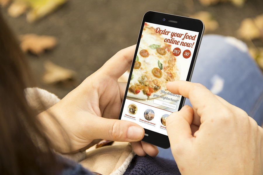 woman ordering food with phone in the park Market Restaurant COVID-19
