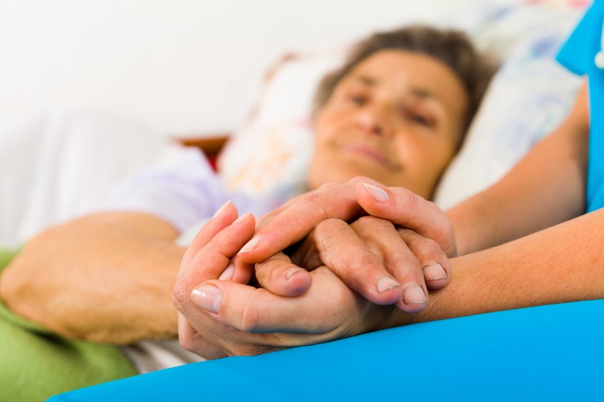 nurse holding patient hand