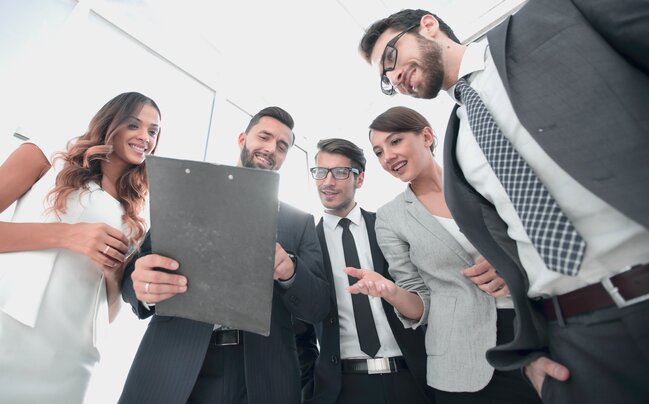 marketing team looking at clipboard