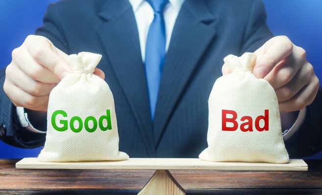 bags labeled good and bad on scale