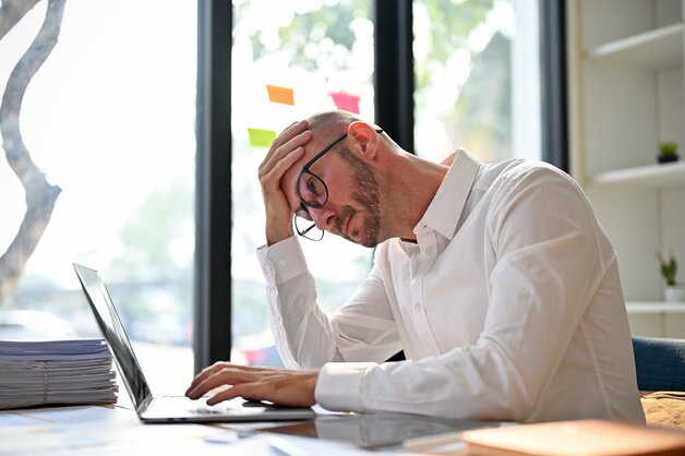 discouraged man with laptop